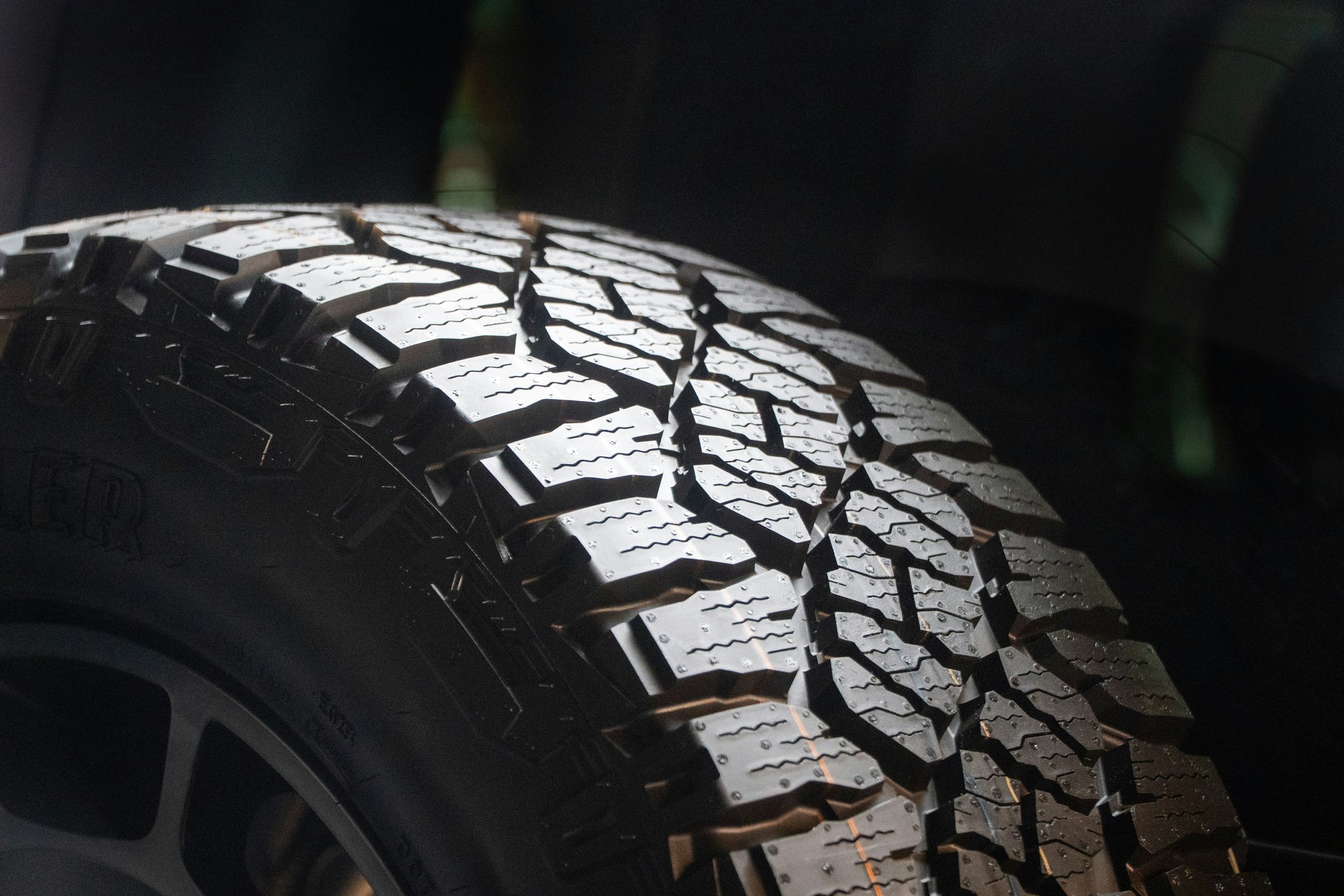 Racing tire tread shoulder in low-key studio light
