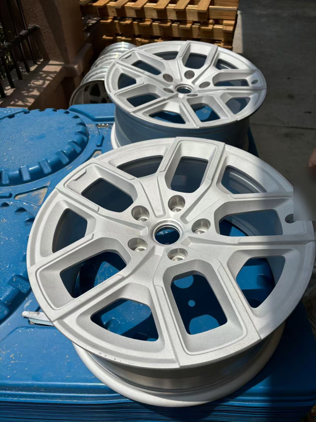 Silver machined wheels on a pallet